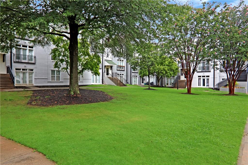 502 Pryor Street Southwest, Unit 113 Atlanta, GA 30312 - Photo 17 of 21 a front view of a house with garden and trees