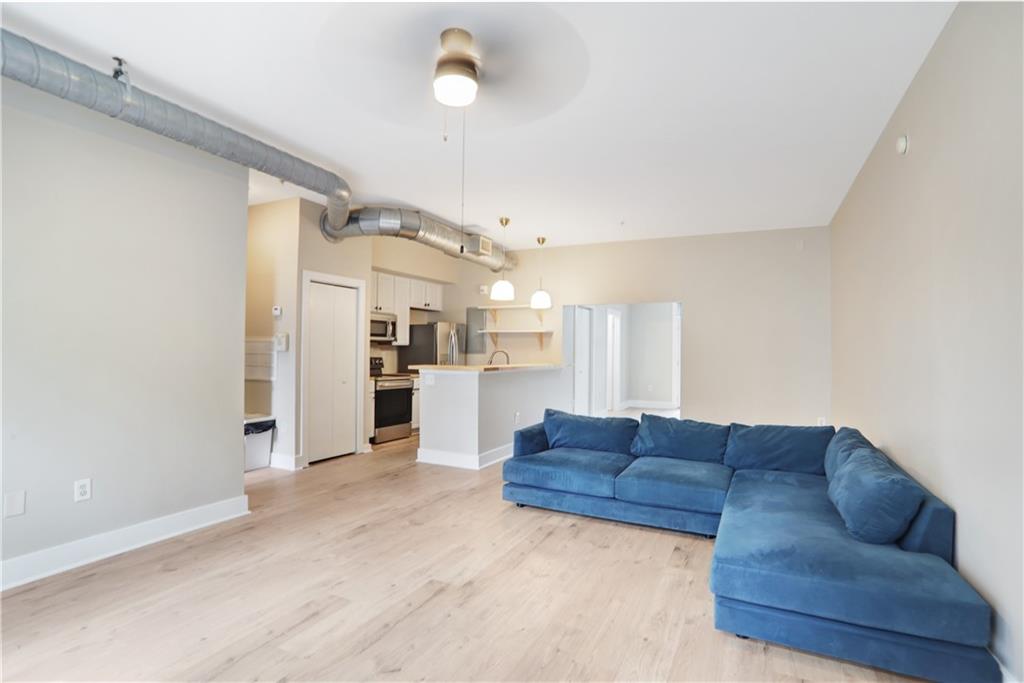 502 Pryor Street Southwest, Unit 113 Atlanta, GA 30312 - Photo 6 of 21 a living room with furniture and kitchen view