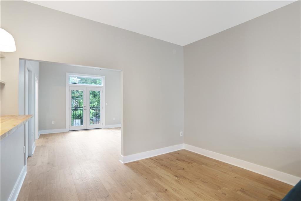 502 Pryor Street Southwest, Unit 113 Atlanta, GA 30312 - Photo 7 of 21 an empty room with wooden floor and windows