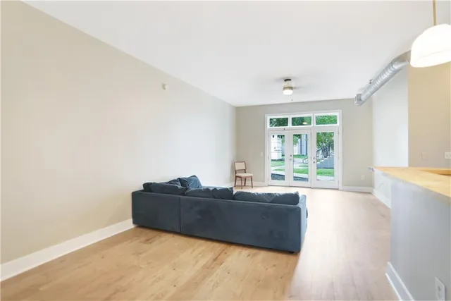 a living room with a bed furniture and a large window