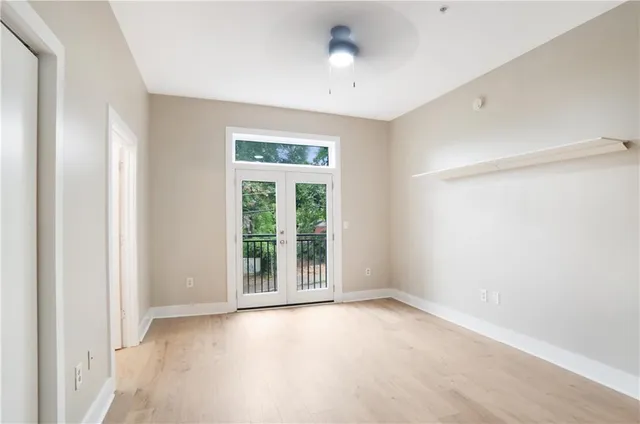 an empty room with windows and closet