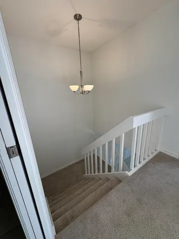 a view of a hallway with a chandelier