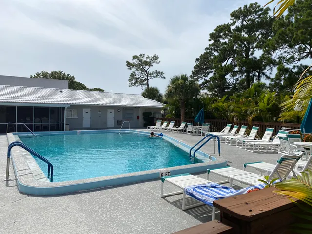a view of a house with swimming pool and sitting area
