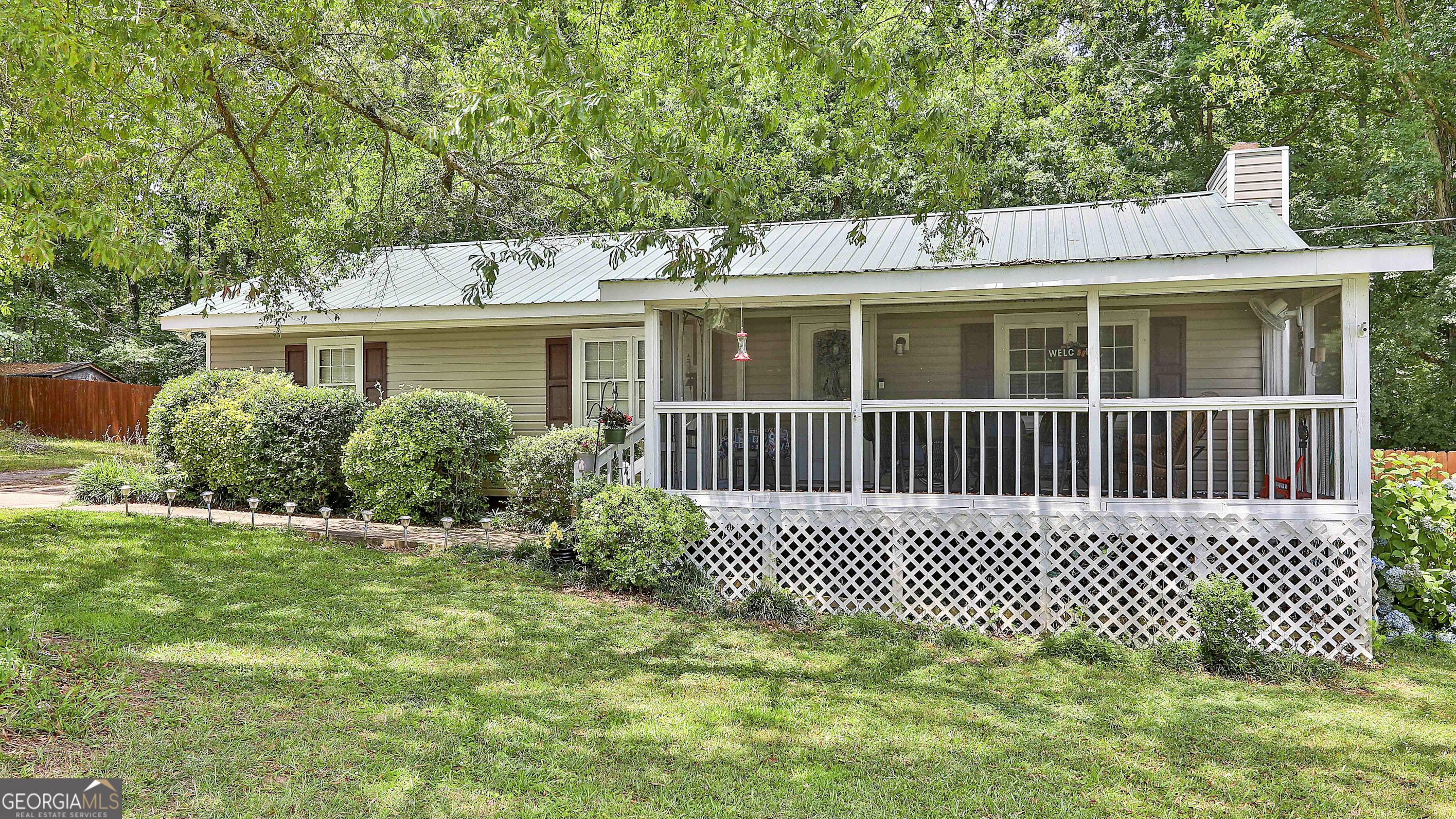 63 Cline Road Moreland, GA 30259 - Photo 1 of 1 a front view of a house with a garden