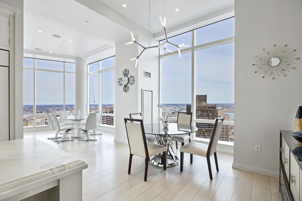 1 Franklin Street, Unit PH1B Boston, MA 02110 - Photo 14 of 42 a view of a a dining room with furniture window and wooden floor