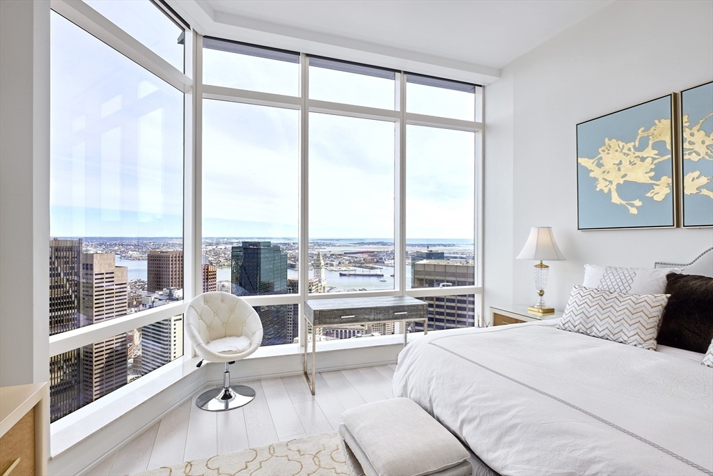 1 Franklin Street, Unit PH1B Boston, MA 02110 - Photo 17 of 42 a bedroom with a large window and a bed