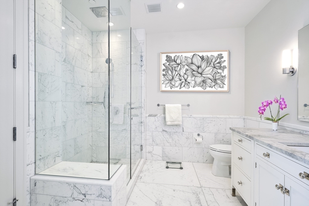 1 Franklin Street, Unit PH1B Boston, MA 02110 - Photo 23 of 42 a bathroom with a granite countertop sink a toilet and shower