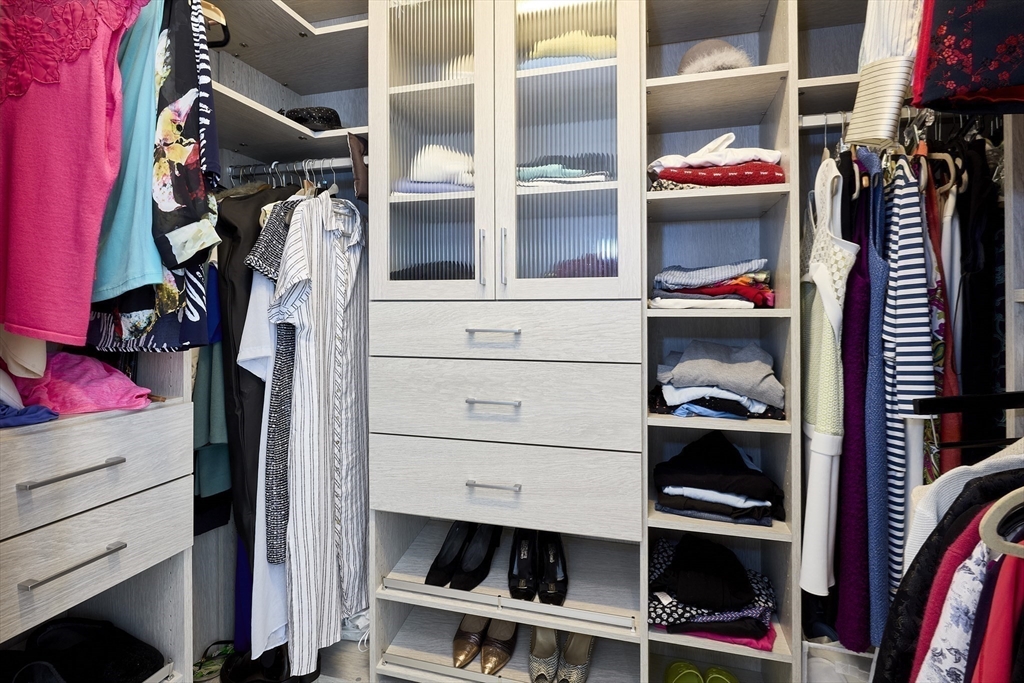 1 Franklin Street, Unit PH1B Boston, MA 02110 - Photo 24 of 42 a view of walk in closet with clothes and shoes
