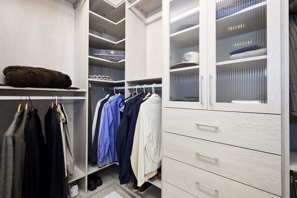 1 Franklin Street, Unit PH1B Boston, MA 02110 - Photo 25 of 42 a view of walk in closet with clothes and shoes