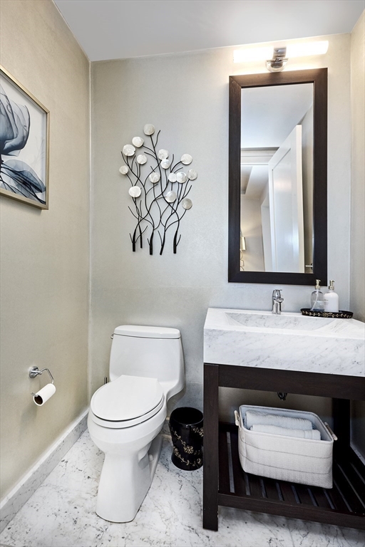 1 Franklin Street, Unit PH1B Boston, MA 02110 - Photo 28 of 42 a bathroom with a toilet sink and mirror
