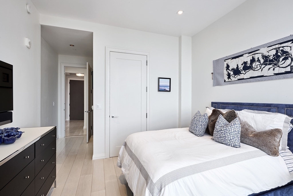 1 Franklin Street, Unit PH1B Boston, MA 02110 - Photo 31 of 42 a bedroom with a bed and a mirror