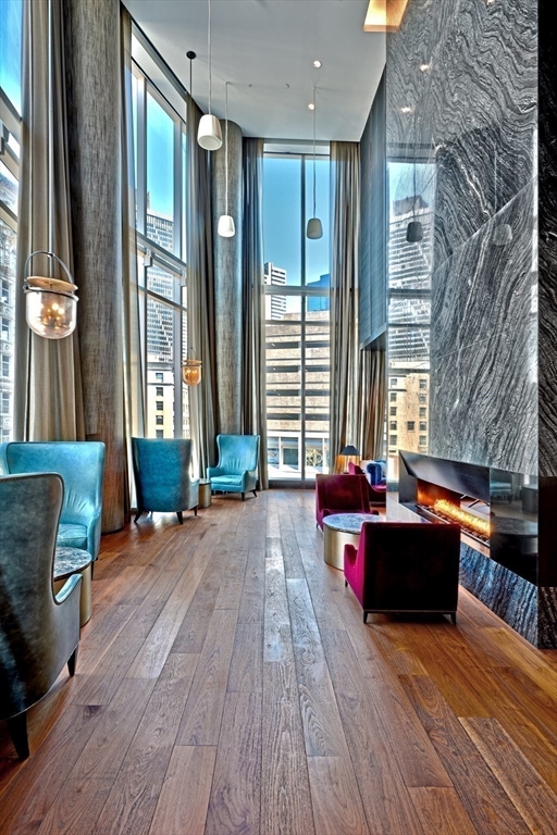 1 Franklin Street, Unit PH1B Boston, MA 02110 - Photo 36 of 42 a living room filled with furniture window and wooden floor