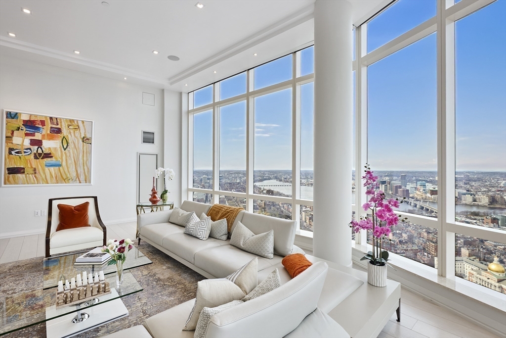 1 Franklin Street, Unit PH1B Boston, MA 02110 - Photo 6 of 42 a living room with furniture and flowers