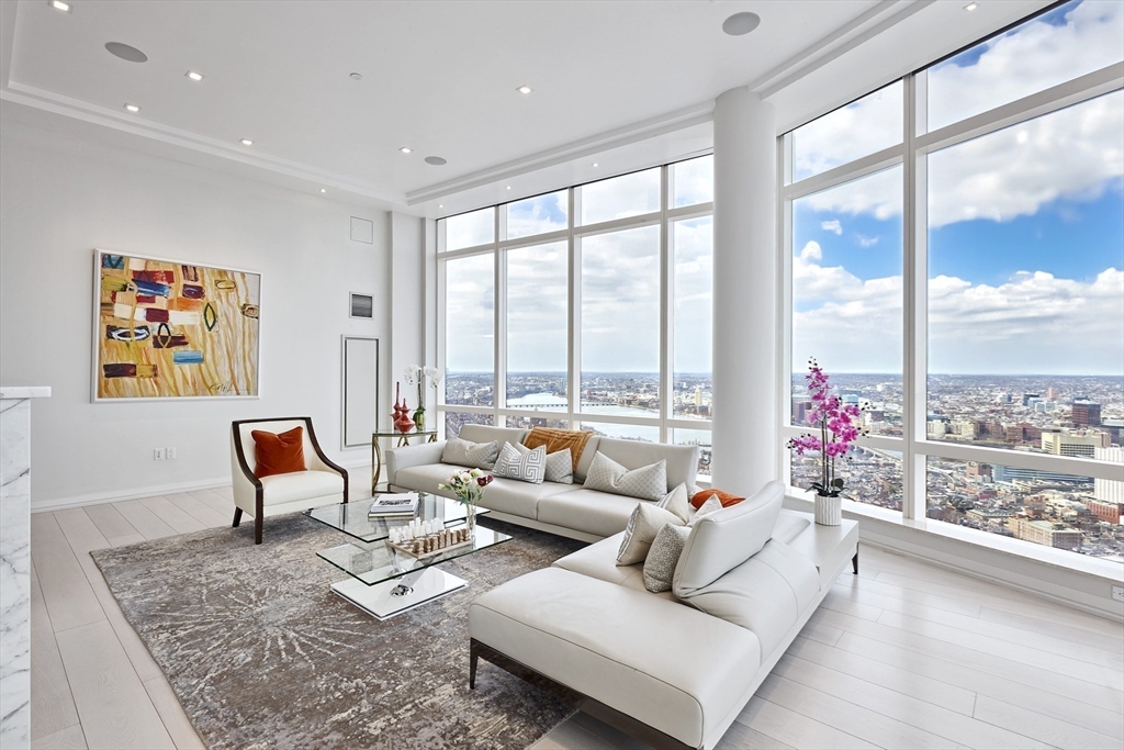 1 Franklin Street, Unit PH1B Boston, MA 02110 - Photo 7 of 42 a living room with furniture and floor to ceiling window