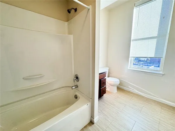 a bathroom with a bathtub and toilet