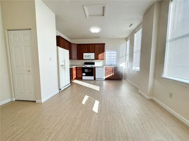 a view of a kitchen with furniture and wooden floor