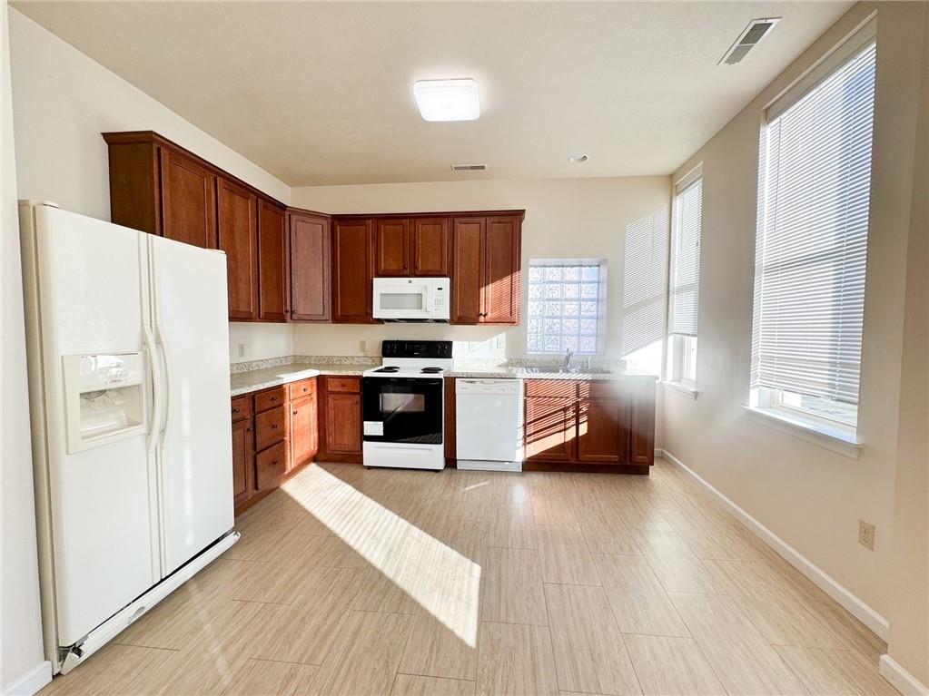 137 North Main Street, Unit D Butler, PA 16001 - Photo 3 of 12 a kitchen with granite countertop a refrigerator a sink a stove top oven a cabinetry and a potted plant