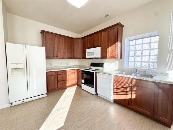 a kitchen with stainless steel appliances a refrigerator sink and cabinets