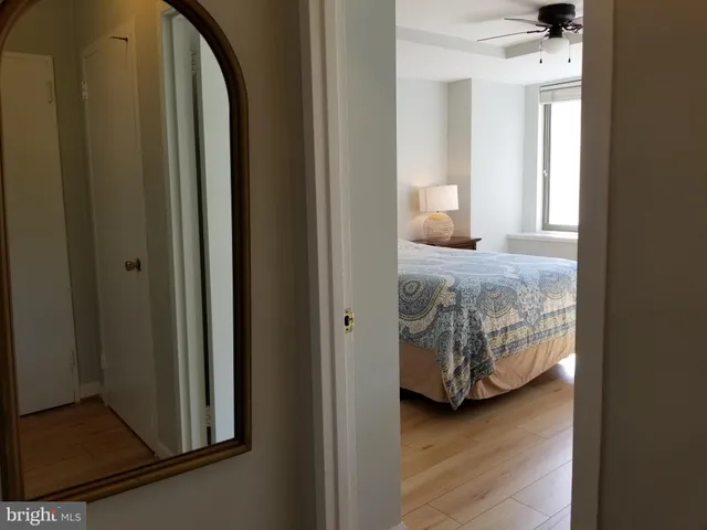 a en suite bathroom with a granite countertop sink and a mirror