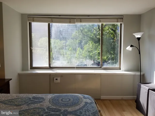 a bathroom with a window and a shower