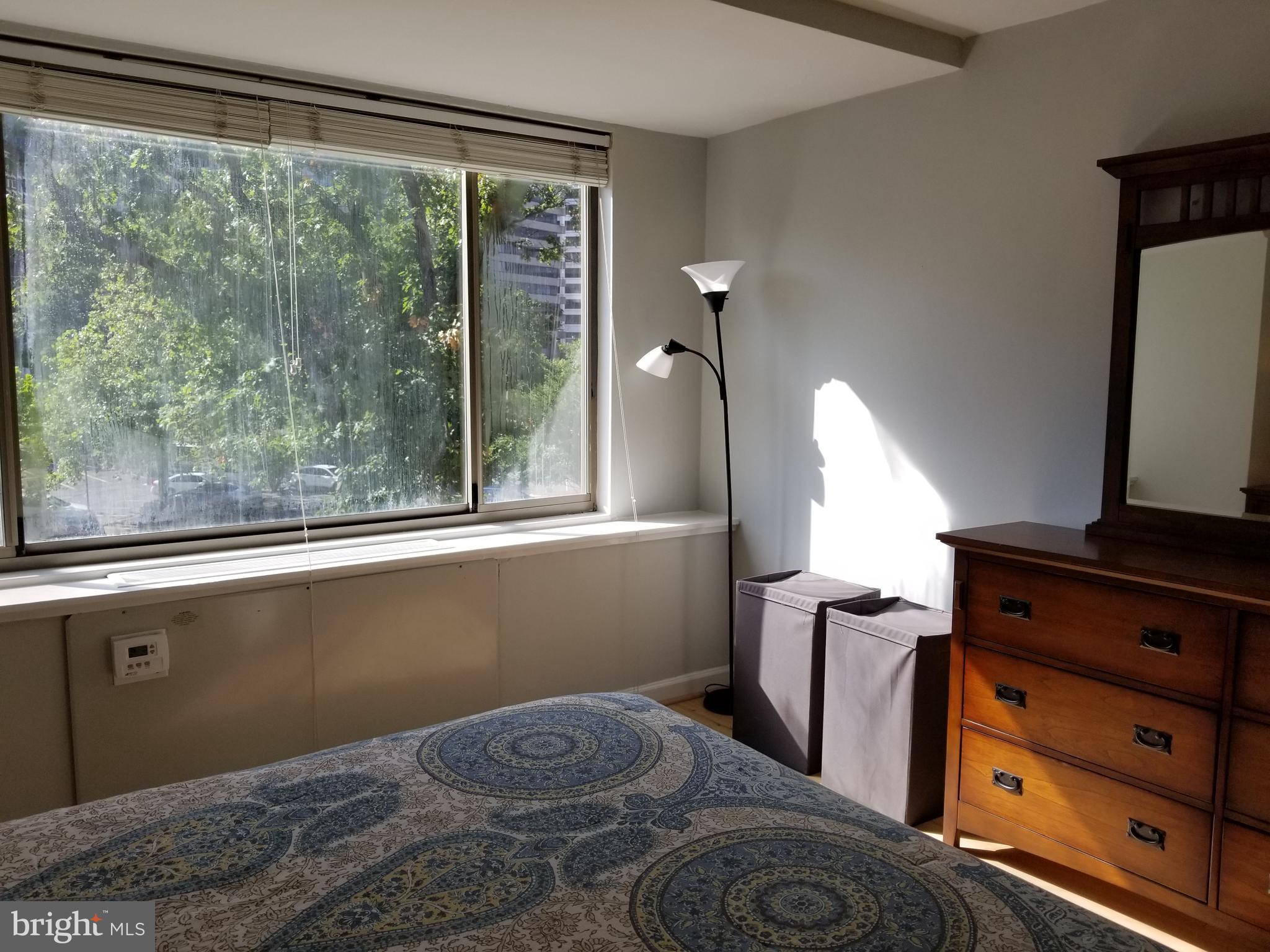 1111 Arlington Boulevard, Unit 307 Arlington, VA 22209 - Photo 17 of 36 a bedroom with a bed and large window