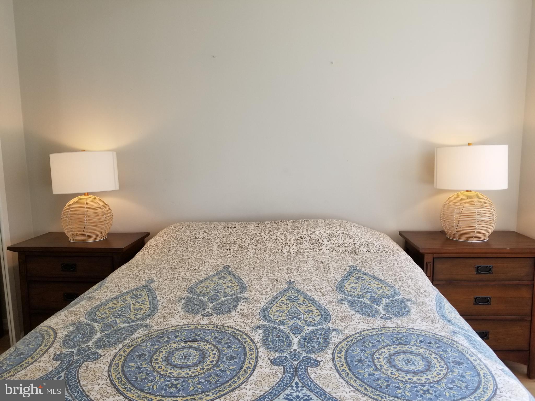 1111 Arlington Boulevard, Unit 307 Arlington, VA 22209 - Photo 20 of 36 a bedroom with a bed and a lamp