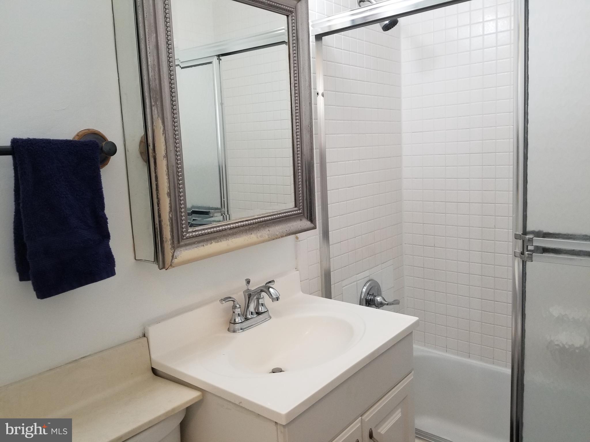 1111 Arlington Boulevard, Unit 307 Arlington, VA 22209 - Photo 21 of 36 a bathroom with a sink and a mirror