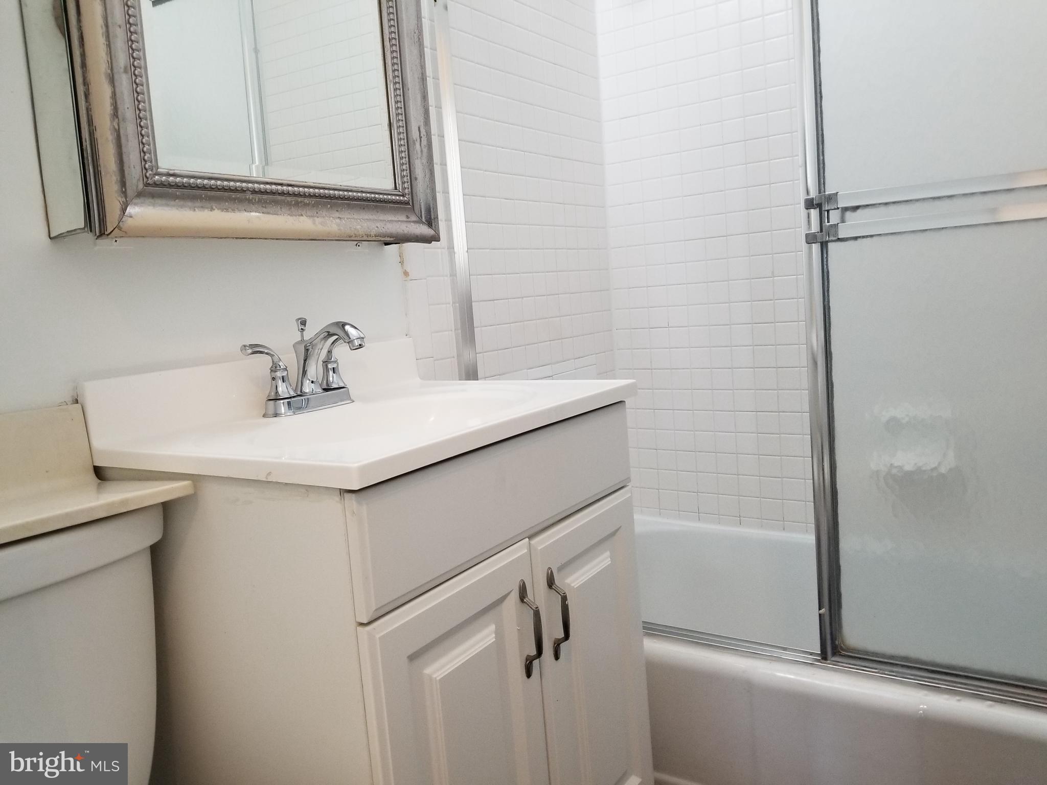 1111 Arlington Boulevard, Unit 307 Arlington, VA 22209 - Photo 22 of 36 a bathroom with a sink and a mirror
