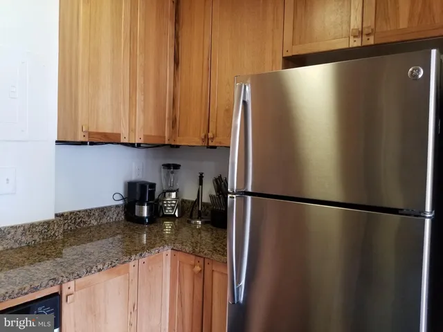 a kitchen with metallic refrigerator freezer and a dishwasher