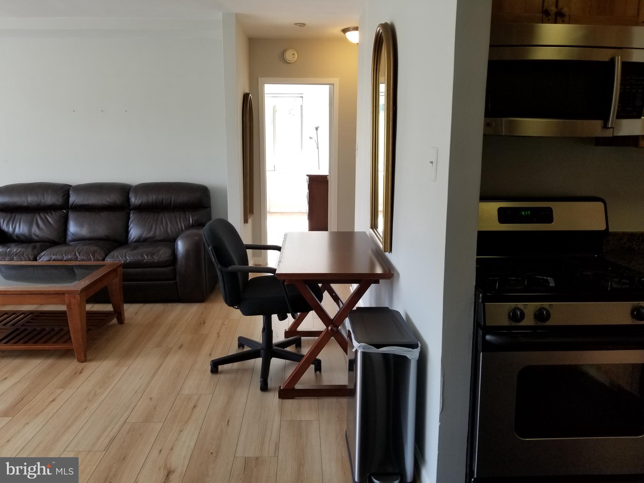 1111 Arlington Boulevard, Unit 307 Arlington, VA 22209 - Photo 4 of 36 a workspace with furniture and wooden floor