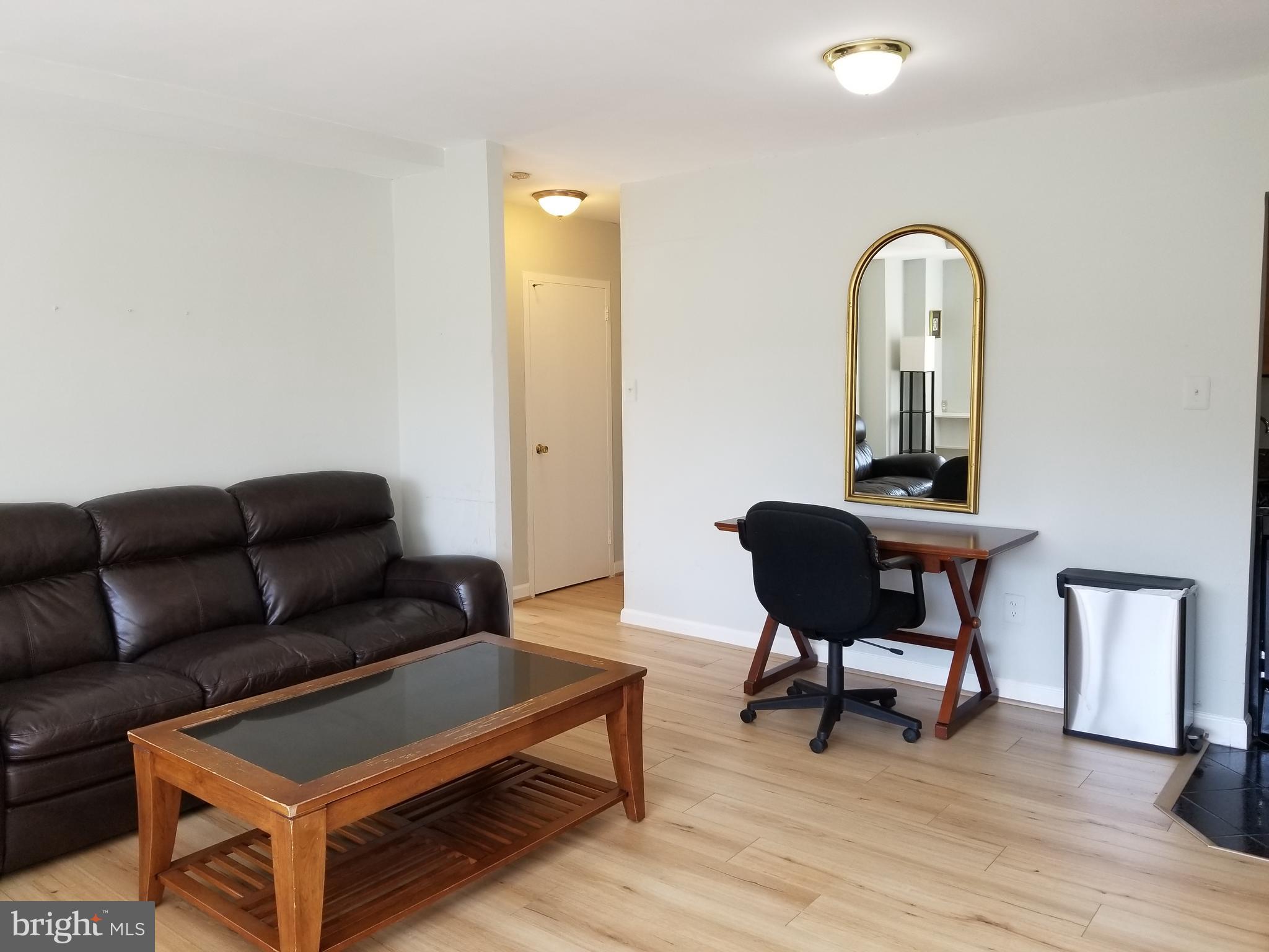 1111 Arlington Boulevard, Unit 307 Arlington, VA 22209 - Photo 7 of 36 a living room with furniture and a mirror