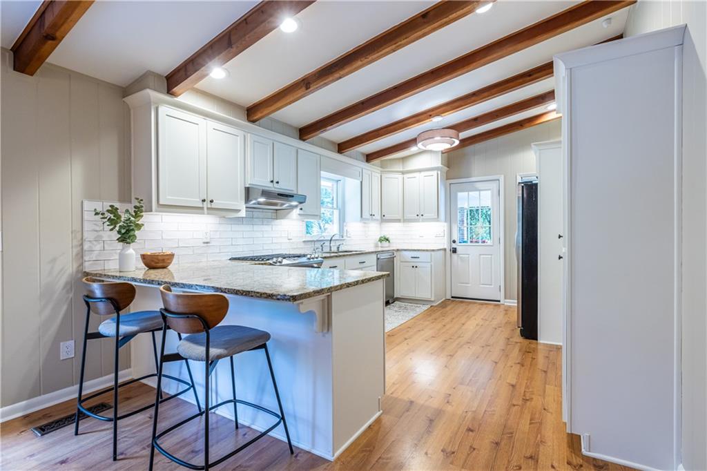 1890 Silvastone Drive Decatur, GA 30033 - Photo 13 of 48 a kitchen with granite countertop wooden floors and white stainless steel appliances