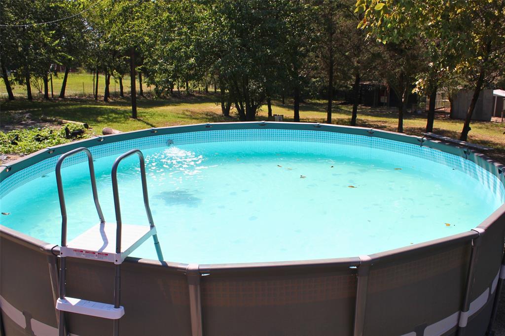 12608 Valverde Loop Terrell, TX 75161 - Photo 19 of 26 a view of swimming pool with an outdoor space and seating area