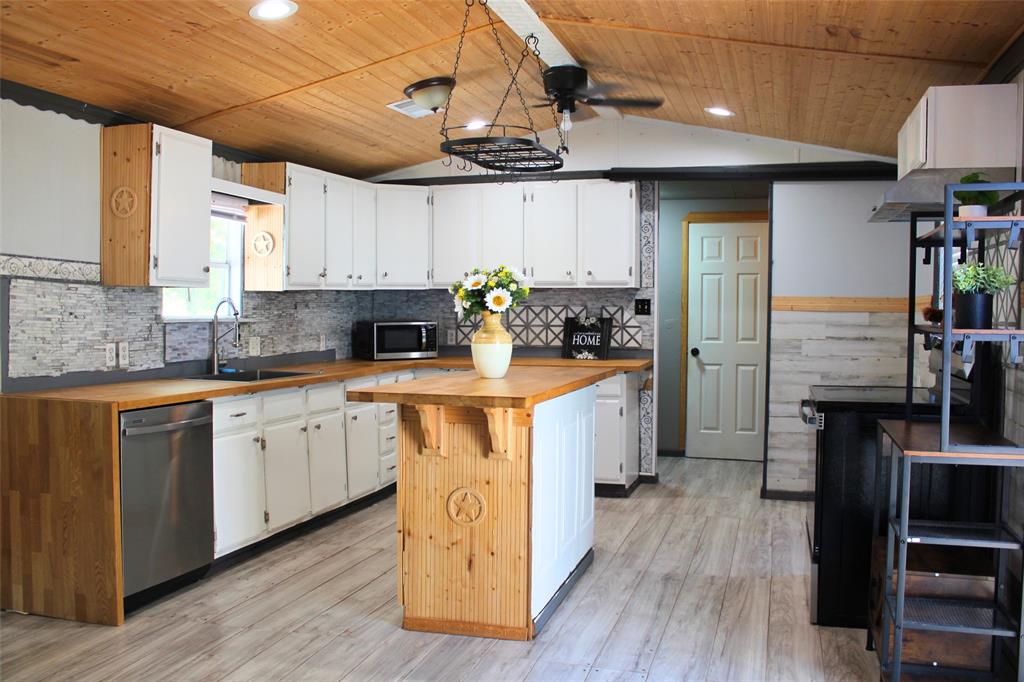 12608 Valverde Loop Terrell, TX 75161 - Photo 2 of 26 a kitchen with cabinets appliances wooden floor and a window