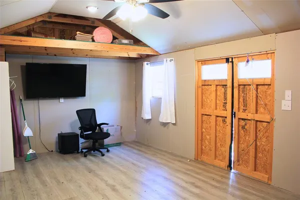 a view of workspace with wooden floor and windows