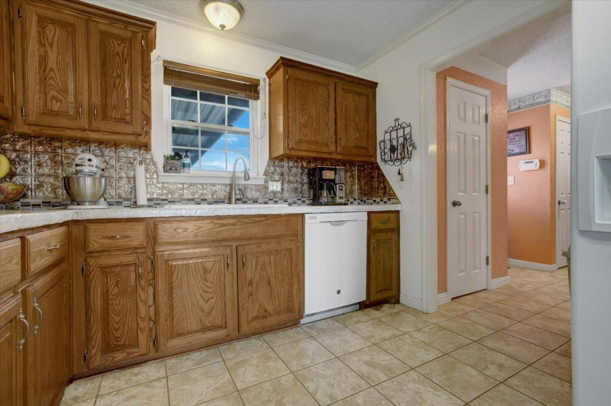 1703 Owl Road Lubbock, TX 79407 - Photo 12 of 33 a kitchen with cabinets a sink and appliances