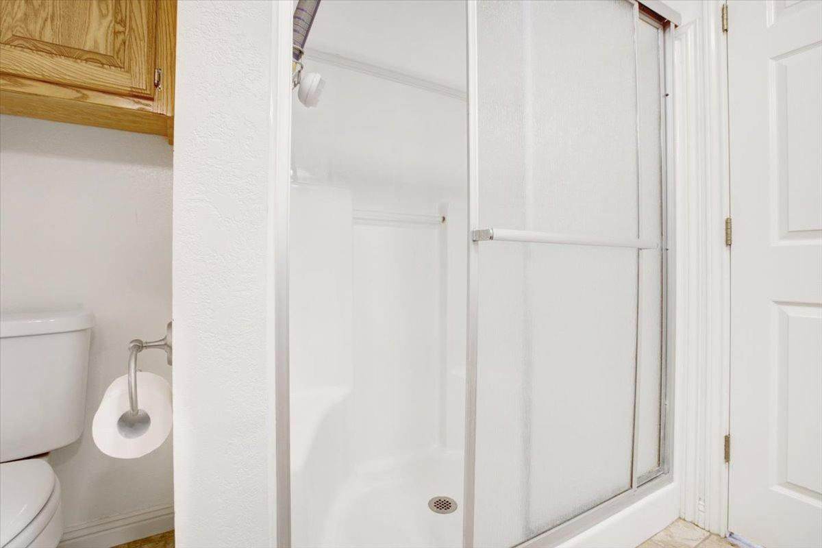 1703 Owl Road Lubbock, TX 79407 - Photo 15 of 33 a white toilet sitting next to a shower