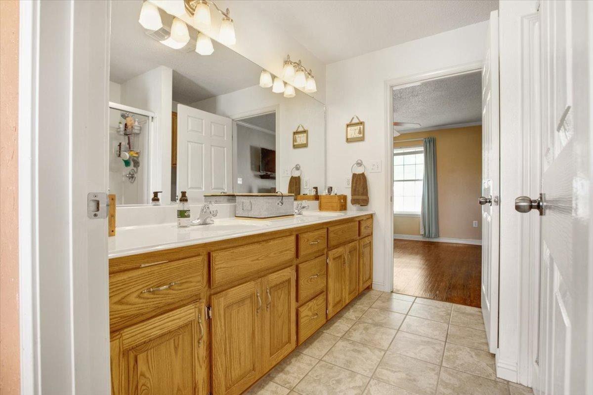 1703 Owl Road Lubbock, TX 79407 - Photo 16 of 33 a spacious bathroom with a mirror sink and shower