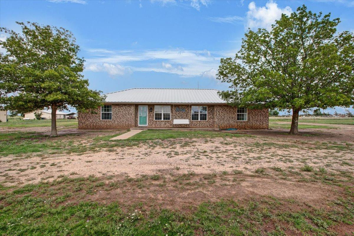1703 Owl Road Lubbock, TX 79407 - Photo 2 of 33 a front view of a house with a yard