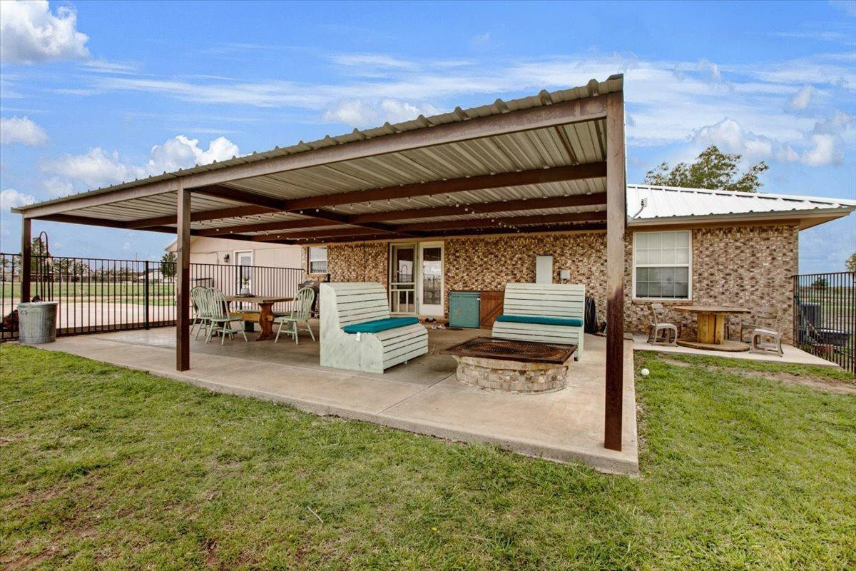 1703 Owl Road Lubbock, TX 79407 - Photo 22 of 33 a view of a porch with furniture and a backyard