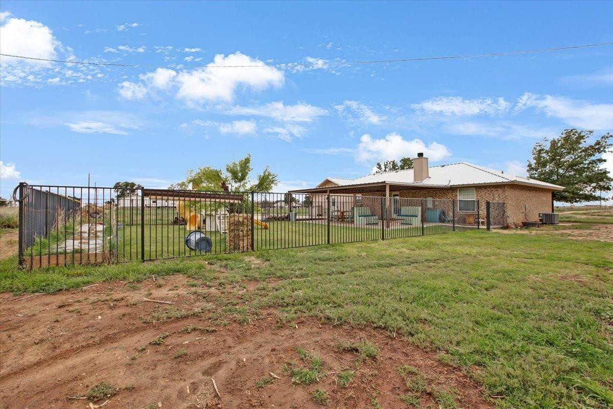 1703 Owl Road Lubbock, TX 79407 - Photo 23 of 33 a view of a house with a yard and sitting area