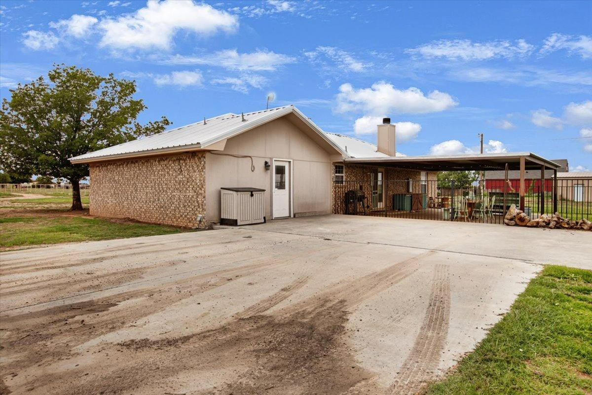 1703 Owl Road Lubbock, TX 79407 - Photo 24 of 33 a view of a white house with a yard