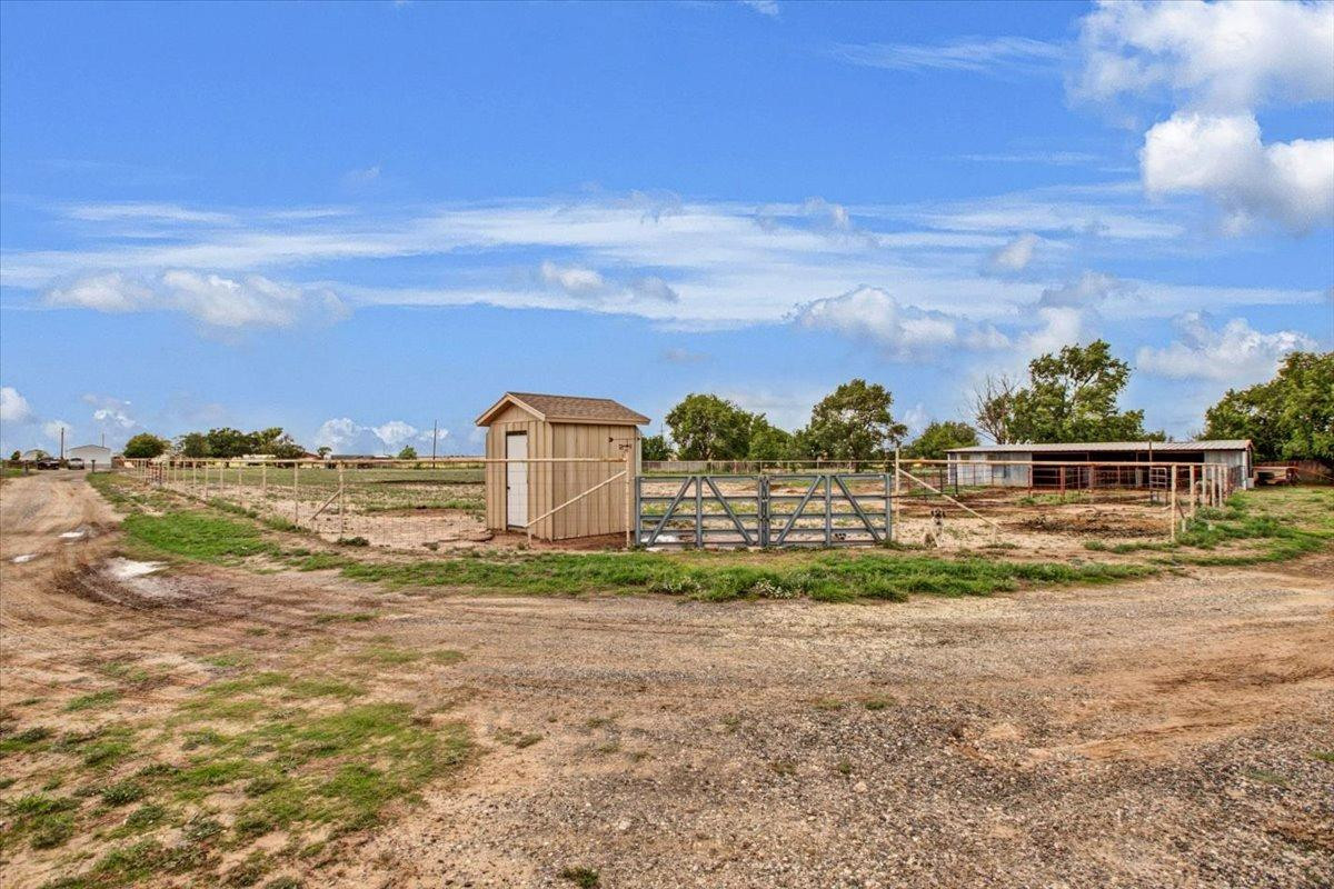 1703 Owl Road Lubbock, TX 79407 - Photo 27 of 33 a view of a garden with a building in the background
