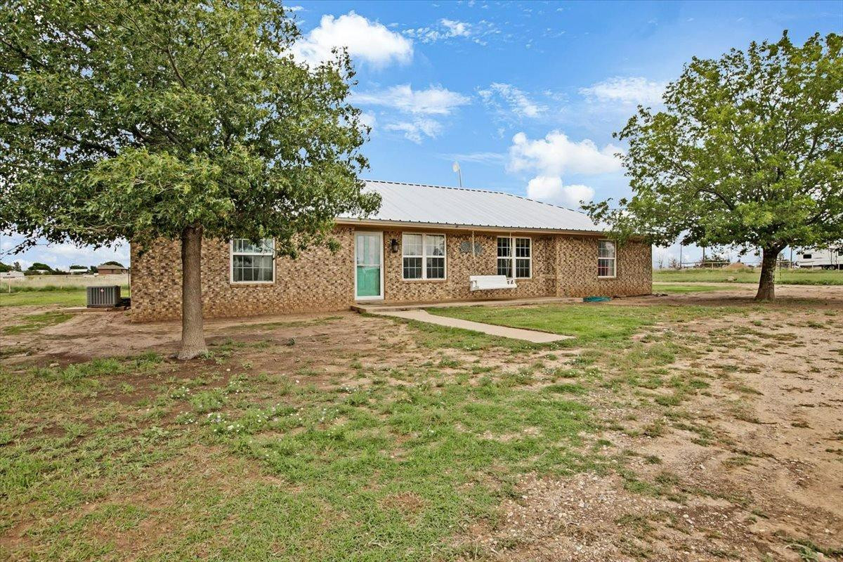1703 Owl Road Lubbock, TX 79407 - Photo 3 of 33 a front view of a house with a yard