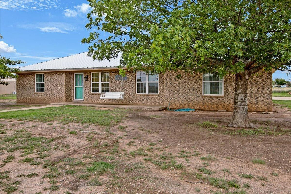 1703 Owl Road Lubbock, TX 79407 - Photo 4 of 33 a front view of a house with a garden