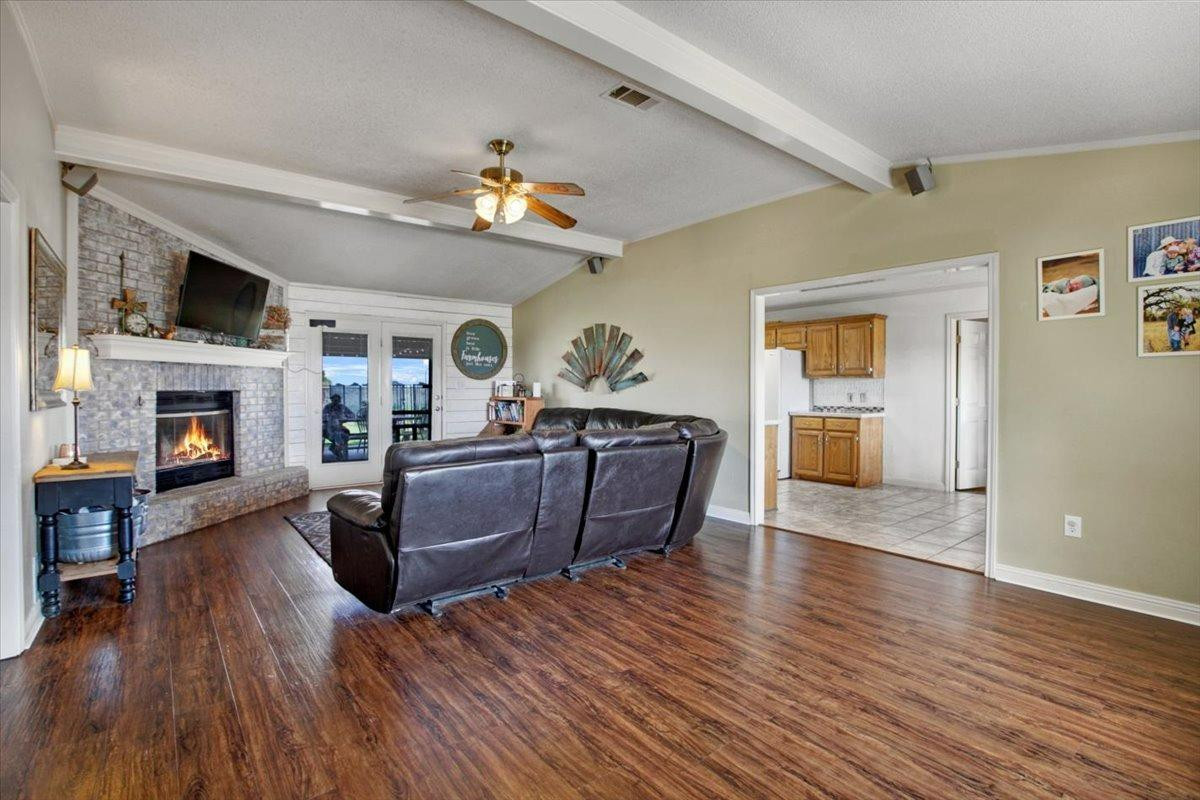 1703 Owl Road Lubbock, TX 79407 - Photo 5 of 33 a living room with furniture and a fireplace