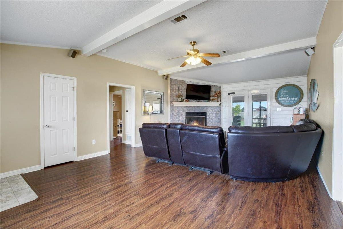 1703 Owl Road Lubbock, TX 79407 - Photo 6 of 33 a living room with furniture and a flat screen tv