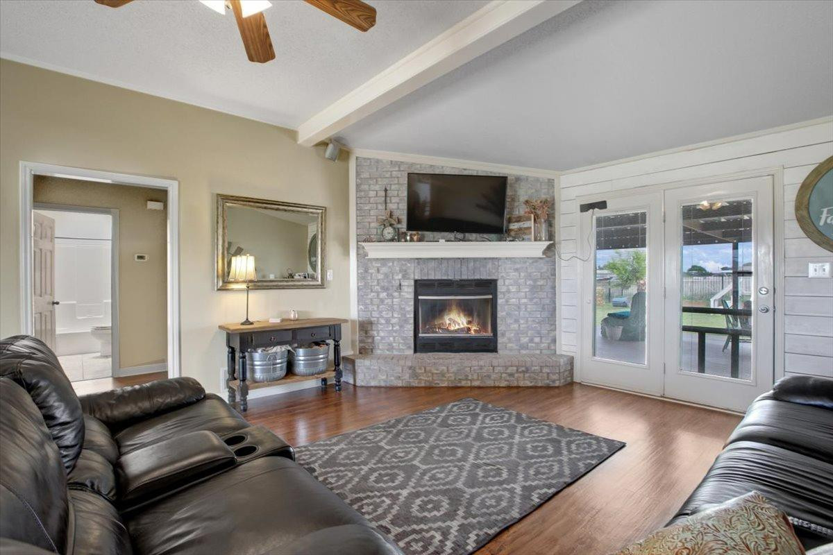 1703 Owl Road Lubbock, TX 79407 - Photo 7 of 33 a living room with furniture and a fireplace