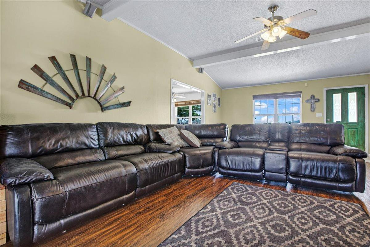 1703 Owl Road Lubbock, TX 79407 - Photo 8 of 33 a living room with lots of furniture and a rug