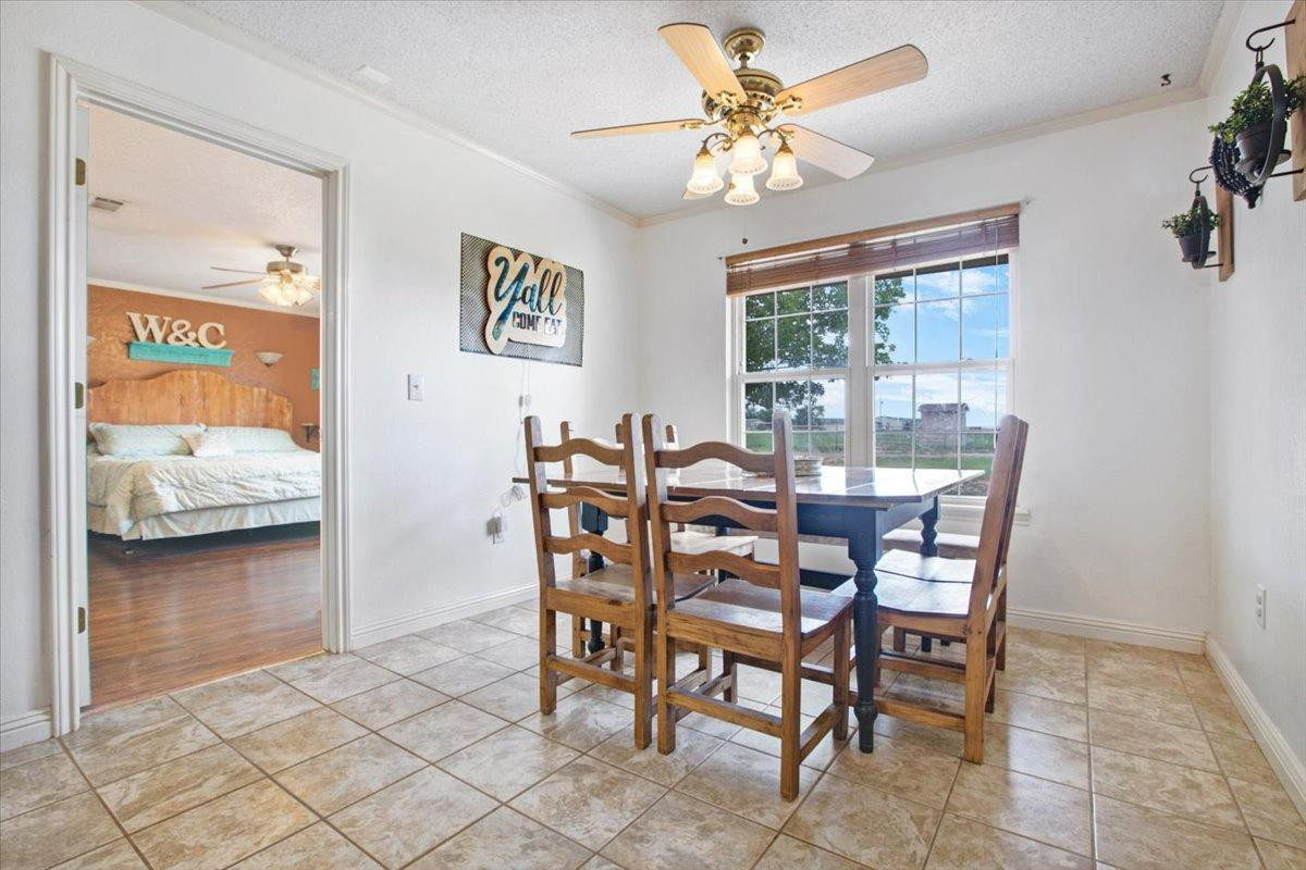 1703 Owl Road Lubbock, TX 79407 - Photo 9 of 33 a view of a dining room with furniture and a chandelier